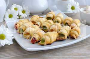 Plate with homemade croissants filled with colorful jelly