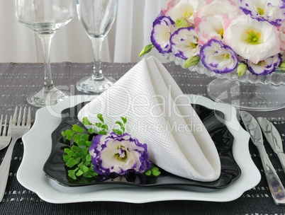 Black and white dishes served with a napkin with flowers