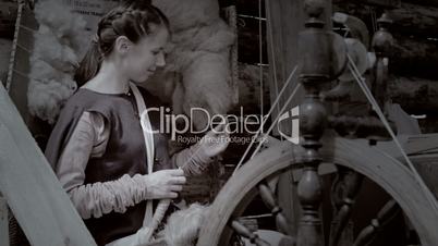 Young female spinning yarn.