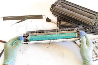 hands repairing toner cartridge