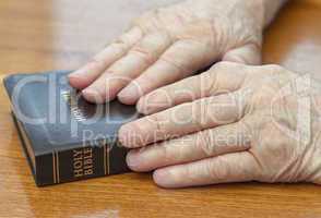 old man hands on bible
