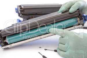 hands repairing toner cartridge