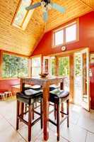 Luxury vaulted wood ceiling dining room with red walls.