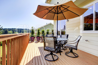 Deck with table, chairs and umbrella.