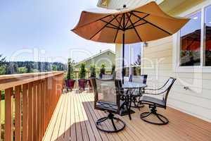Deck with table, chairs and umbrella.