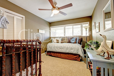 Kids nursery interior with blue and brown bed.