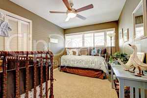 Kids nursery interior with blue and brown bed.