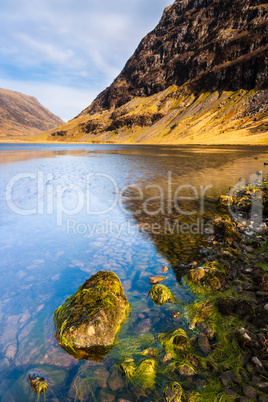Scottish highlands landscape scene with mountain and loch