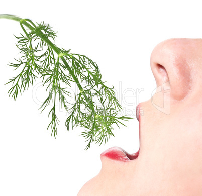 Woman eats a sprig of dill