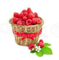 Ripe raspberry with green leaves in a basket. Isolated on white