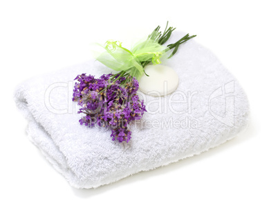 Spa set: towel, soap and  bouquet of lavender on a white backgro