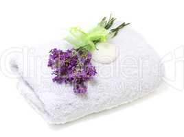Spa set: towel, soap and  bouquet of lavender on a white backgro