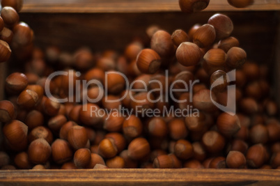 Hazelnuts in Motion Tumbling into Wooden Box