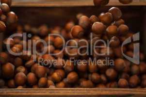 Hazelnuts in Motion Tumbling into Wooden Box