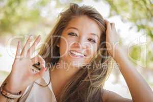 Attractive Mixed Race Girl Portrait with Okay Hand Sign Outdoors