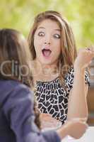 Attractive Shocked Mixed Race Girl Talking with Friend Outside