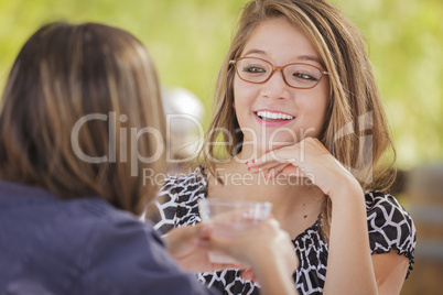 Attractive Mixed Race Girlfriends Talking Over Drinks Outside
