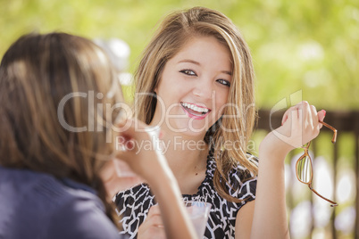 Attractive Mixed Race Girlfriends Talking Over Drinks Outside