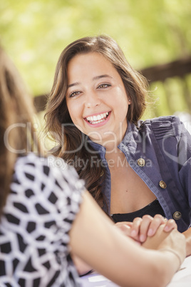 Attractive Girlfriends Laughing Sitting Outside