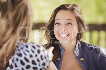 Attractive Girlfriends Laughing Sitting Outside