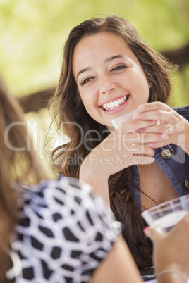 Attractive Girlfriends Laughing Sitting Outside
