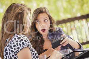 Shocked Mixed Race Girls Working on Electronic Devices