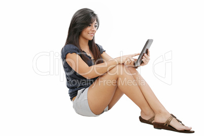 Smiling seated young woman using a tablet pc