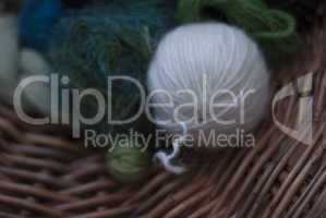 Closeup of soft green and white wools on basket weave
