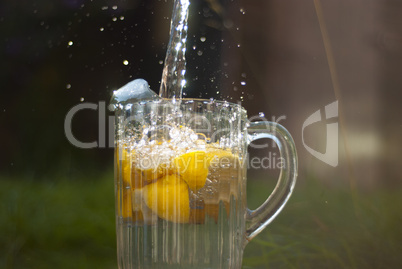 water pouring onto  jug of lemons