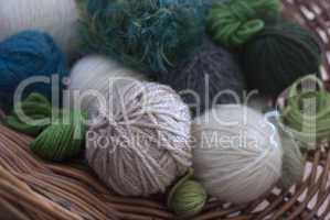 Balls of wool in basket- greens