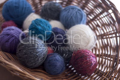 Coloured balls of wool in basket