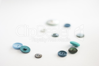 a spiral of blue -green recycled buttons