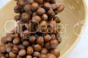 hazelnuts in motion tumbling into bamboo bowl