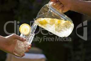 pouring homemade lemonade into glass