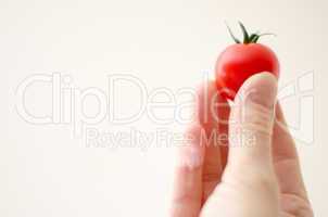 cherry tomatoe in womans fingers