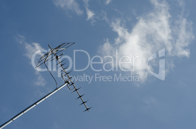 tv antenna on blue sky and fluffy white cloud background