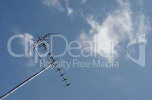 tv antenna on blue sky and fluffy white cloud background