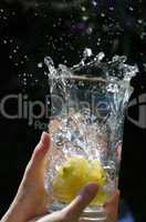 lemons splashing into water