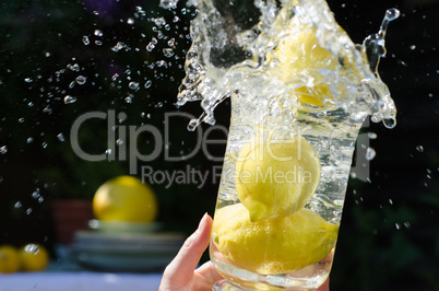 lemons splashing into water