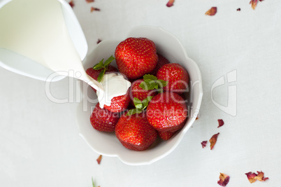 cream poured over fresh strawberrys