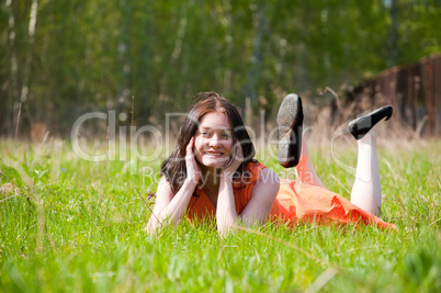 Pretty girl laying on grass