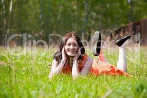 Pretty girl laying on grass