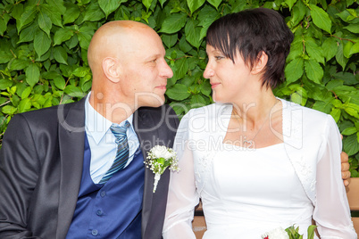 Bridal couple on a park bench