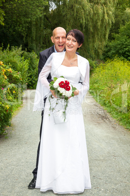 Bridal couple walking in park