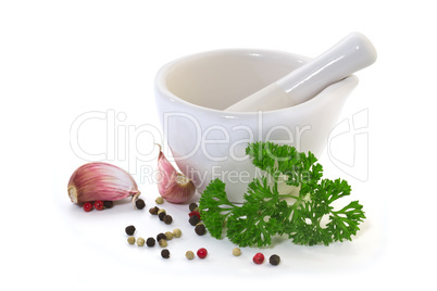 Mortar with garlic and spices on a white background