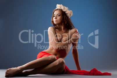 Beautiful young woman in red fabric