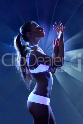 Beauty woman in dance with ultraviolet make-up