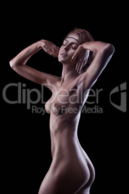 Sexy woman posing nude with metal skin make-up