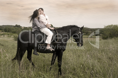 couple and  horse in a field