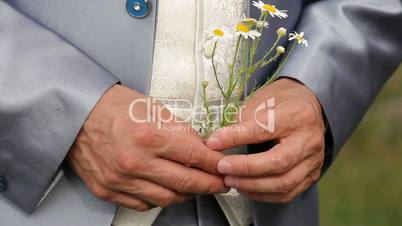 Groom slipping off daisies